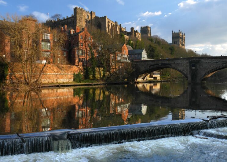 Durham castle, buildings and bridge reflected in the river